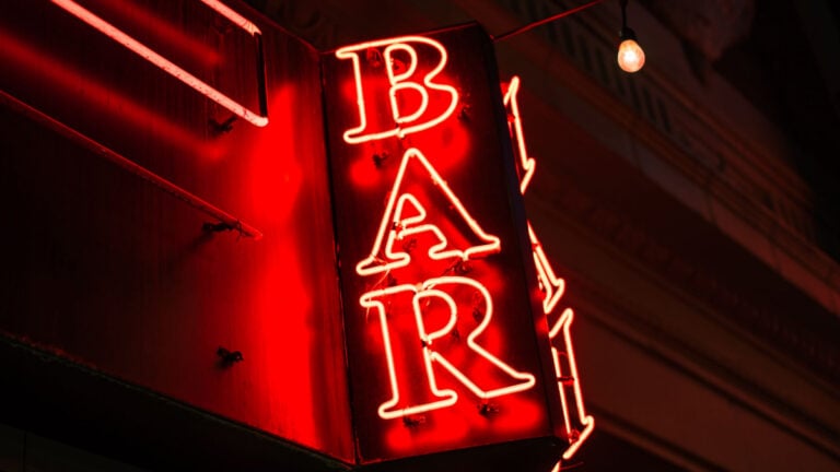 ‘Sorry the Portland Public School System Failed You’: Oregon Bar Openly Mocks Customer Who Complained About 100% Tip Option Illuminated neon bar sign with red glow