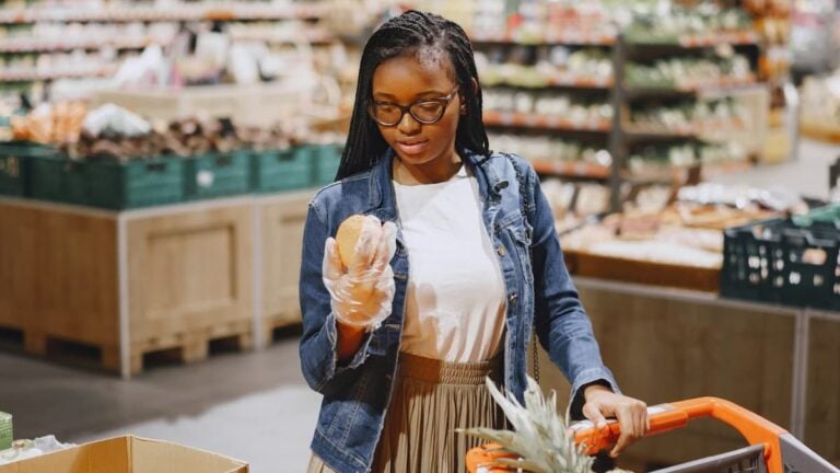 Maryland Shoppers Praise New Ban on Dynamic Grocery Pricing: ‘Good, Now Ban It for Everything Else’ A woman shopping for fresh produce in a vibrant supermarket setting.