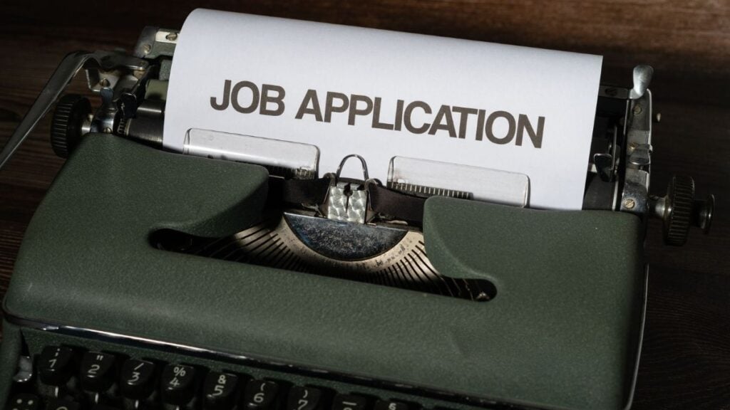 Illinois Man Starts Street Fight Outside Community Center After Getting Rejected for a Job: ‘Weird Way to Do a Follow-Up Letter, But OK’ Close-up of a vintage typewriter with a job application paper inserted.