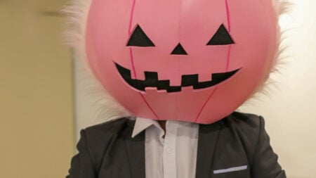 ‘Once Again, We See Christians Pushing Their Beliefs on Others’: Oregon Employee Says CEO Uses Bible Verses to Ban Halloween Costumes A person in a business suit wearing a large pink pumpkin head costume indoors
