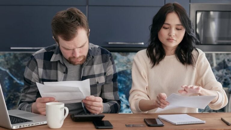 ‘Charge Elon More!’: Memphis Gas and Water Bills Could Climb $28 a Month as Tennessee Residents Push Back A couple reviews bills and manages finances on a kitchen table, looking concerned.