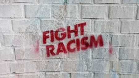 ‘You Smell. Go Back to Your Country’: Texas MAGA Man Hurls Racist Insults at Hispanic Couple at Austin City Limits Festival Graffiti on a brick wall in Hamburg, Germany, with the message 'Fight Racism.'