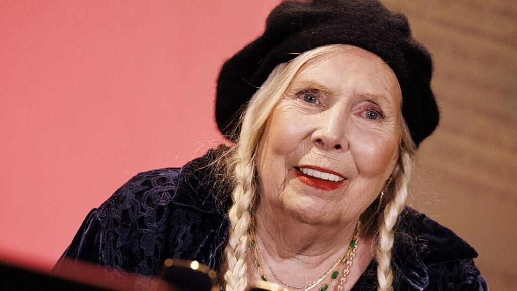 ‘Shows How Broken the Immigration Process Is’: Canadian Singer Joni Mitchell’s 62-Year Journey to US Citizenship Sparks Immigration Debate Joni Mitchell Sitting at Piano