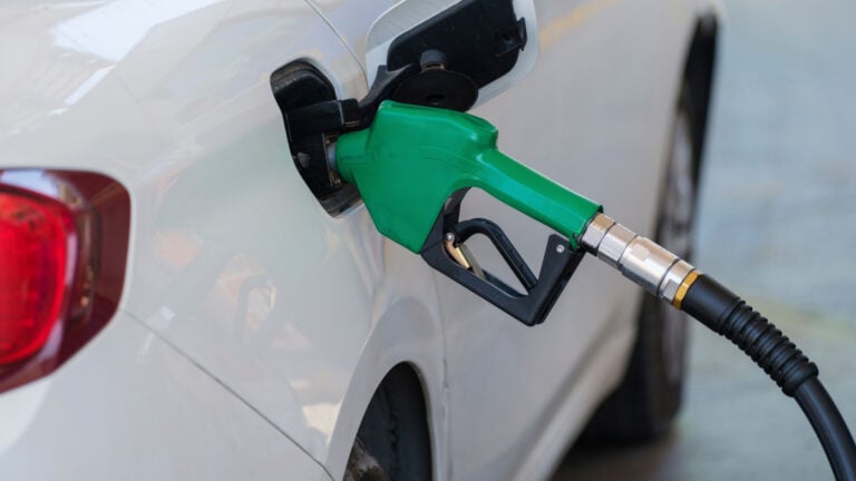 ‘Many of Us Don’t Find Out Until It Hits Us!’: Customer Says $12 Gas Purchase Left Them Unable to Buy Groceries Close-up of a green nozzle refueling a white car at a gas station