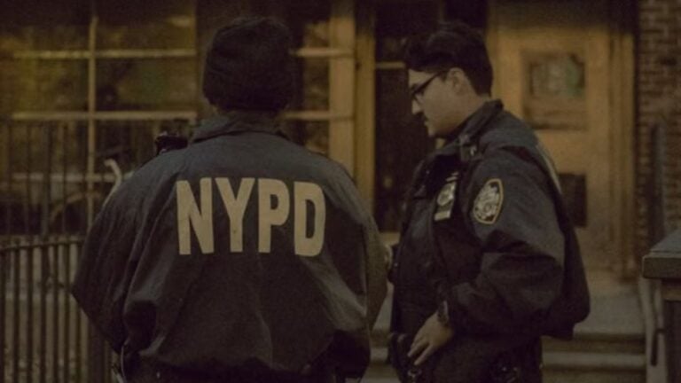Two NYPD officers on duty in New York City, emphasizing urban safety.